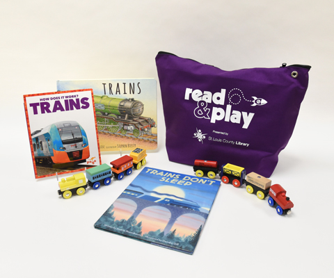 A purple Read & Play Kit bag surrounded by three books on trains with a colorful toddler toy train