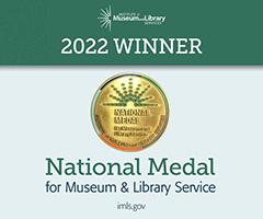 Institute of Museum and Library Services - National Medal for Museum & Library Service with gold medal on two tone green background