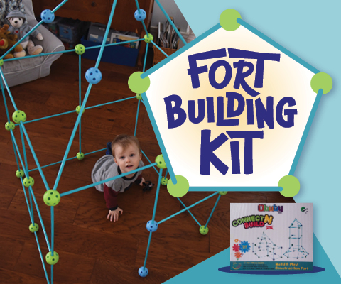 Fort Building Kit - little boy on a hardwood floor inside a fort constructed of light blue and green connectors and plastic tubes