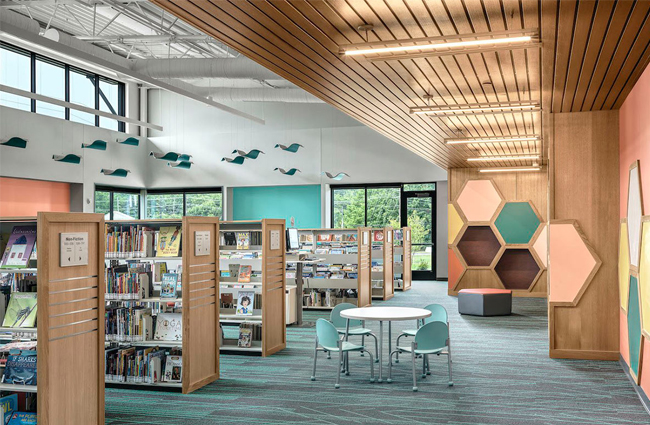 Shelves of books and a small table inside the children's area at the Eureka Hills Branch