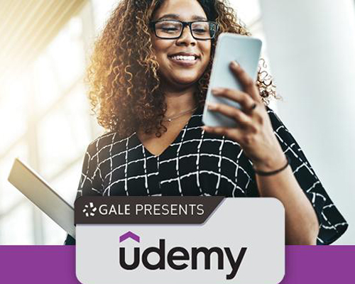 Udemy. African American woman holding a mobile phone.