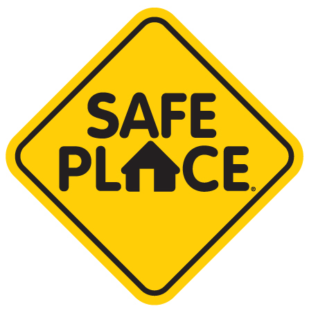 Yellow street looking sign with black text SAFE PLACE and a house symbol in place of the letter A in place