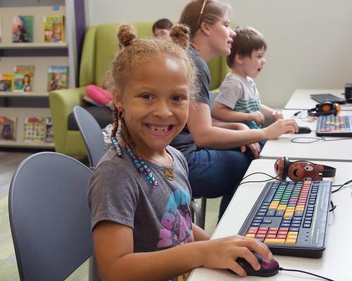 African American child using a computer at the library 