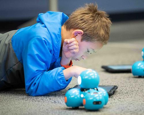 Child working with a coding robot at the library 