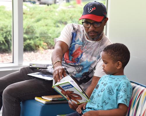 African American father and son reading