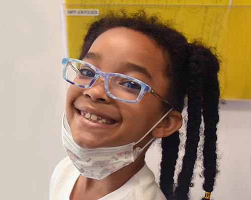 African American child wearing glasses
